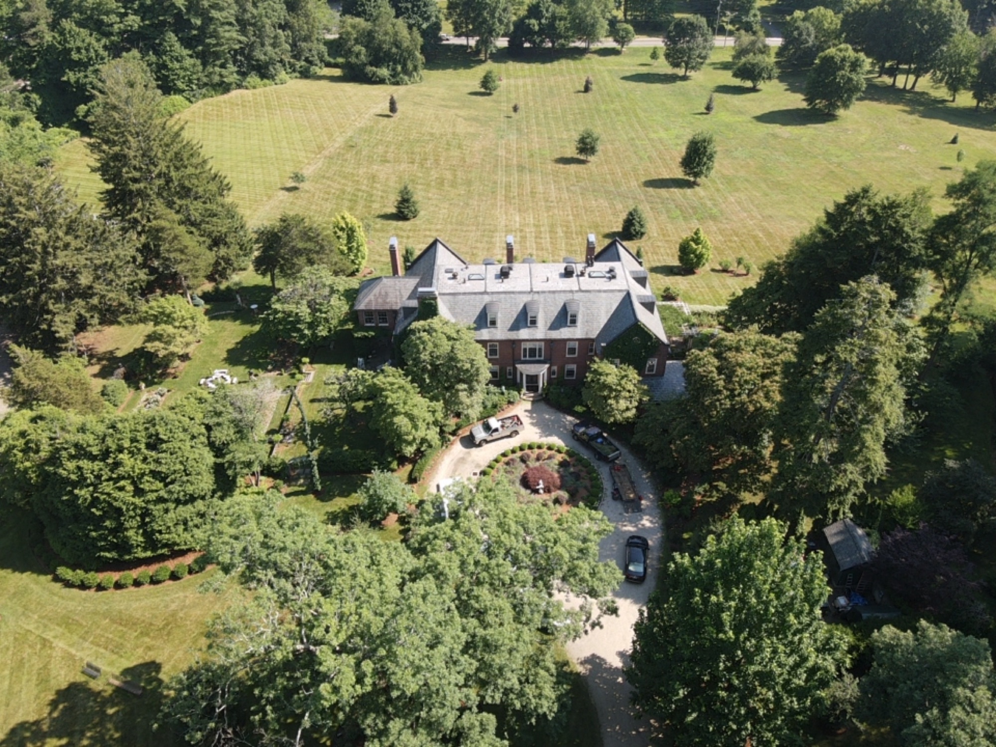 Aerial view of a large estate with expansive striped lawn