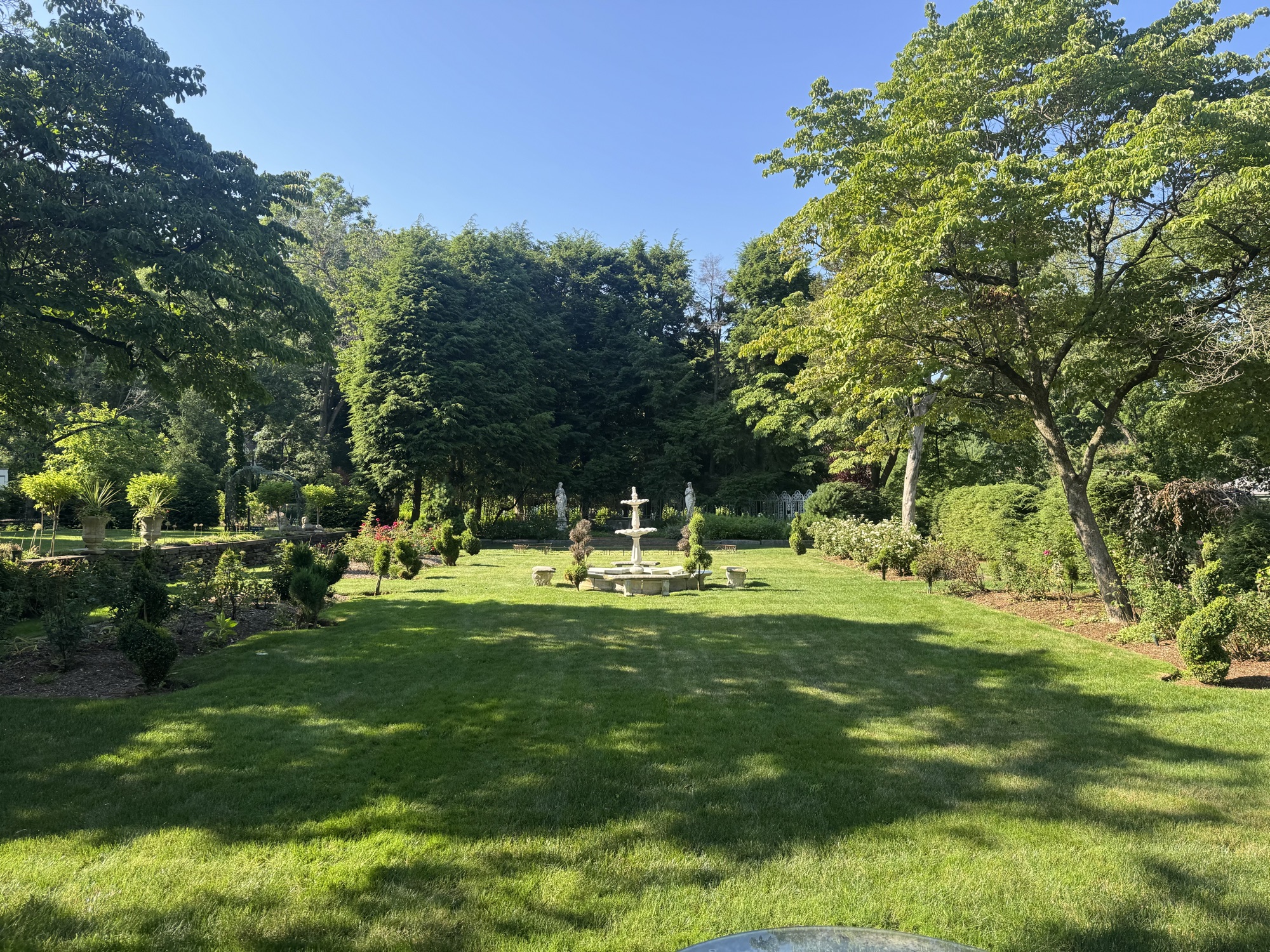Formal garden with fountain and manicured hedges